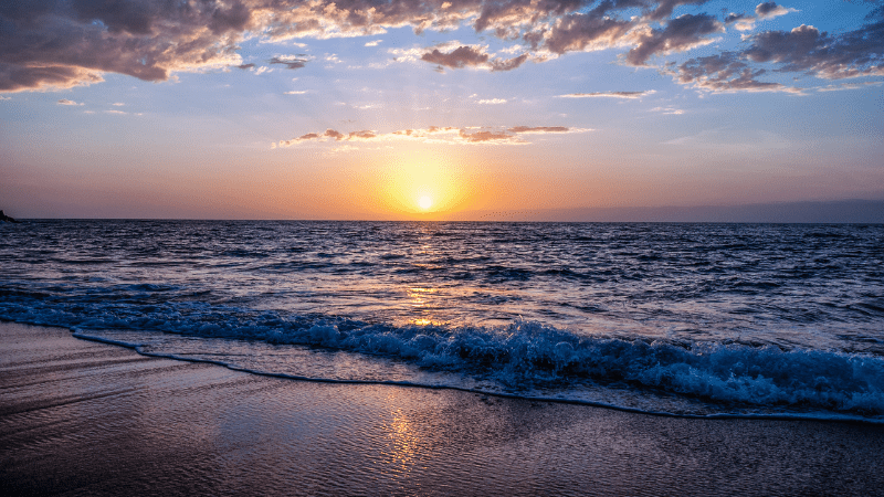 Beautiful-Sunset-Over-Beach-With-Breaking-Waves