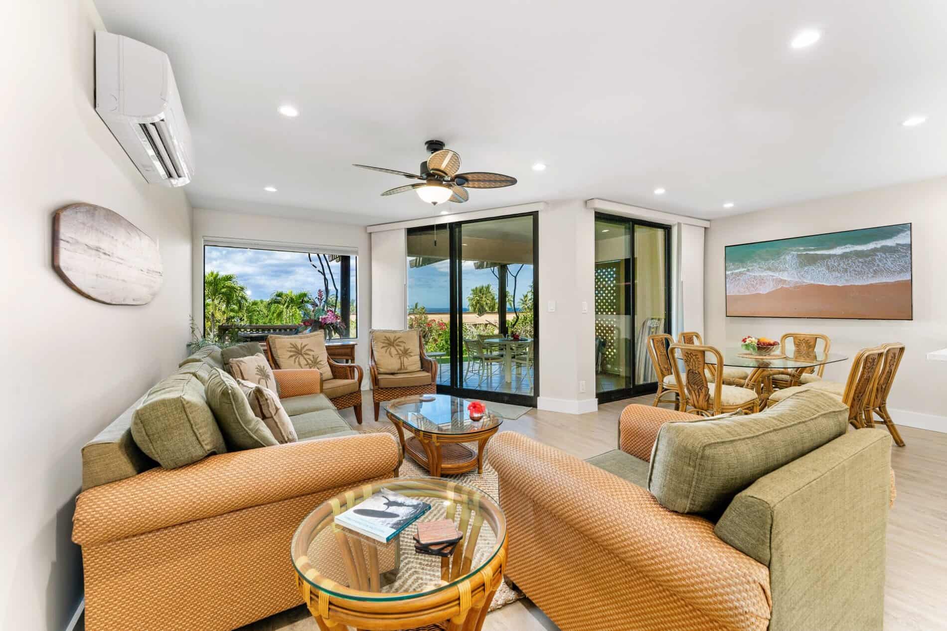 Spacious living room with a large sliding glass door offering scenic views, perfect for a Maui vacation rental.