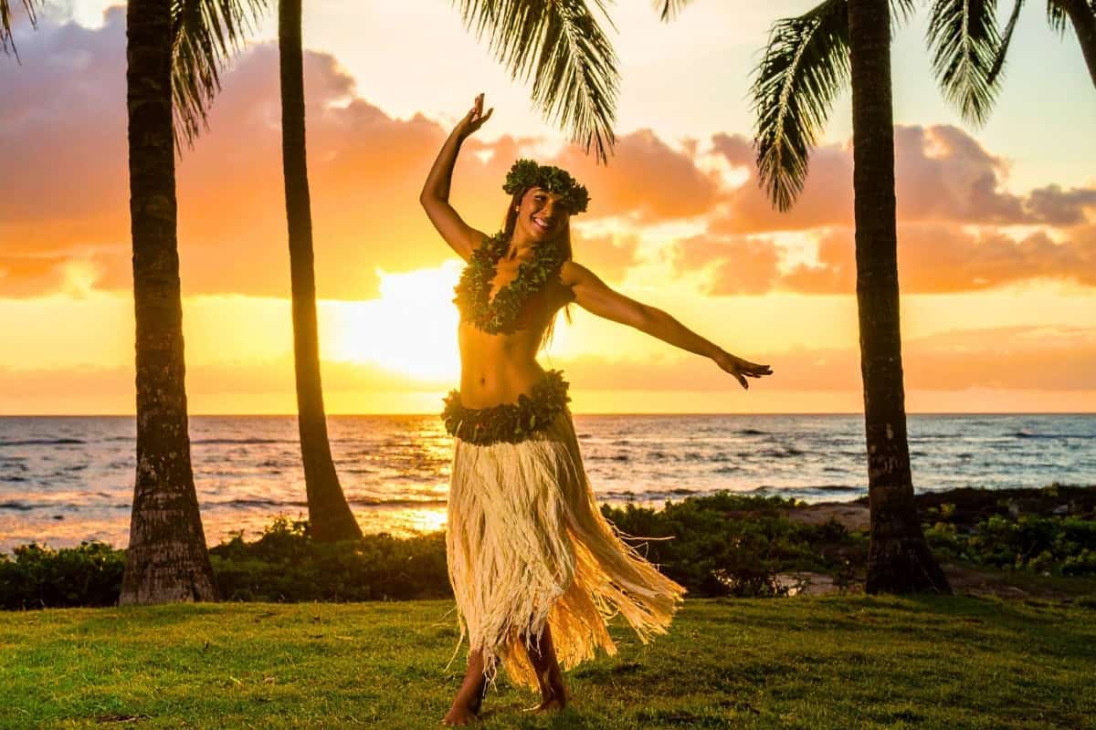 Hula dancer at sunset Hawaii festival Hula dancer in a vibrant skirt performing at sunset, celebrating at a festival on Hawaii's Big Island.