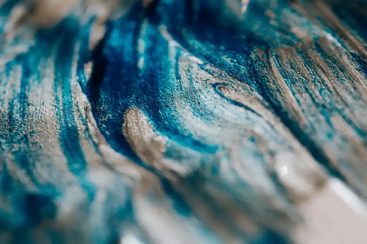Close-up of blue and white paint swirls, evoking creativity and inspiration for planning your 2026 Maui trip.