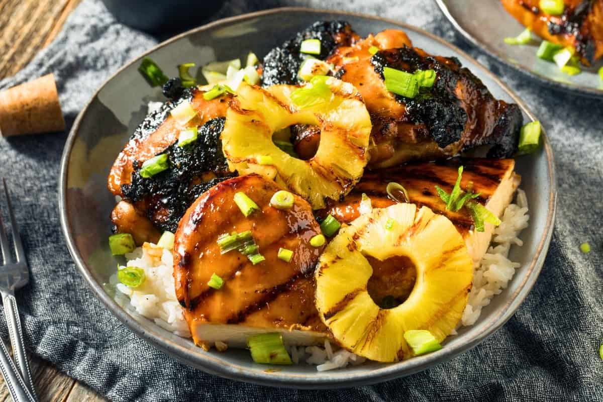 Huli huli chicken with pineapple and rice, a flavorful Maui dish.