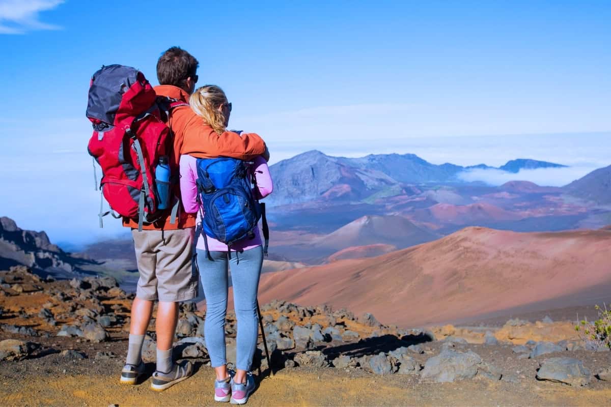 Couple overlooking Haleakala’s volcanic landscape during a Maui adventure.